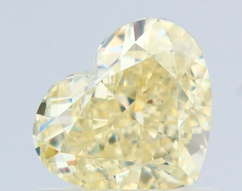 GIA Heart 0.79ct Fancy Light Yellow VVS1 - Loose Natural Diamond: GIA Heart 0.79ct Fancy Light Yellow VVS1 - Loose Natural Diamond GIA certifies this 0.79ct Fancy Light Yellow VVS1 diamond, boasting an EX polish and VG symmetry. Its natural origin shines through in 