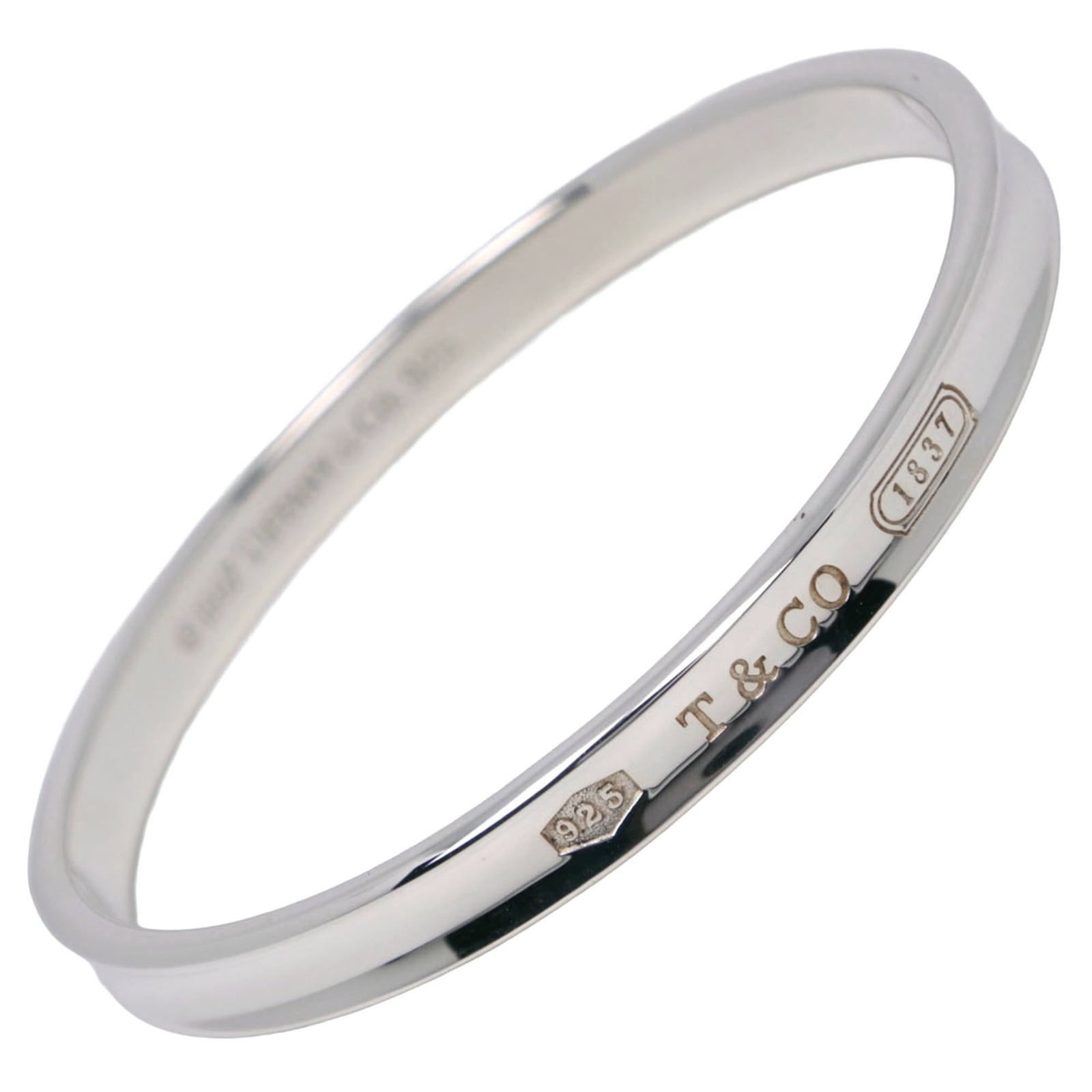 Silver Tiffany Bangle: Silver Tiffany Bangle Silver Tiffany Bangle stands out with its sleek design and premium silver material, measuring 18.5cm in length. This elegant bangle bears a signature, adding a touch of sophistic