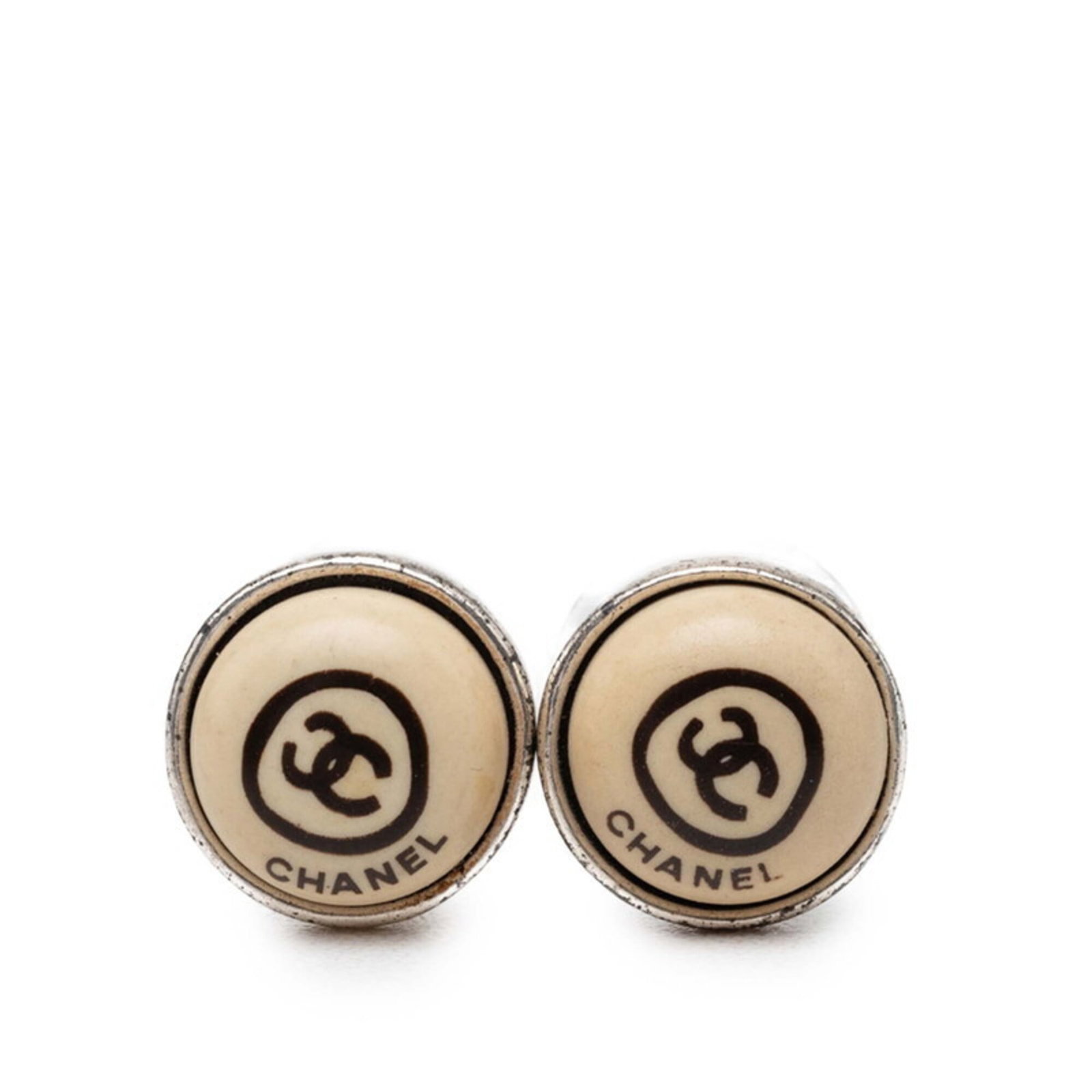 Stud earrings by Chanel: Stud earrings by Chanel Stud earrings by Chanel in beige and silver, measuring 11.20mm x 11.20mm. These classic stud earrings showcase a timeless design with clean lines and understated elegance. A si