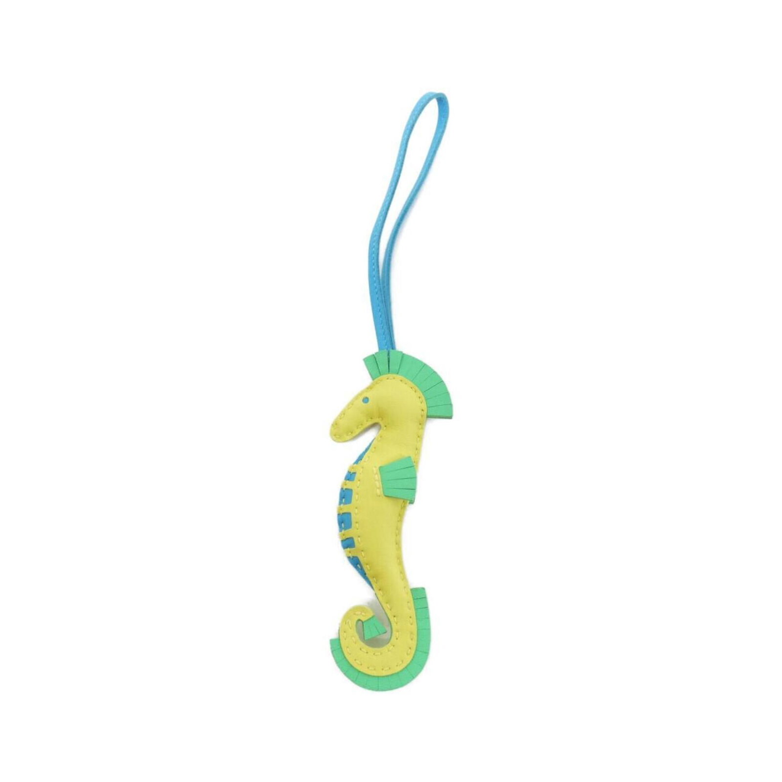 Agneau Handbag Charm Hermes: Agneau Handbag Charm Hermes Agneau Handbag Charm by Hermes features a striking blue, lime, and vert color combination. The agneau material adds an elegant touch to the charm's design, while its chain 