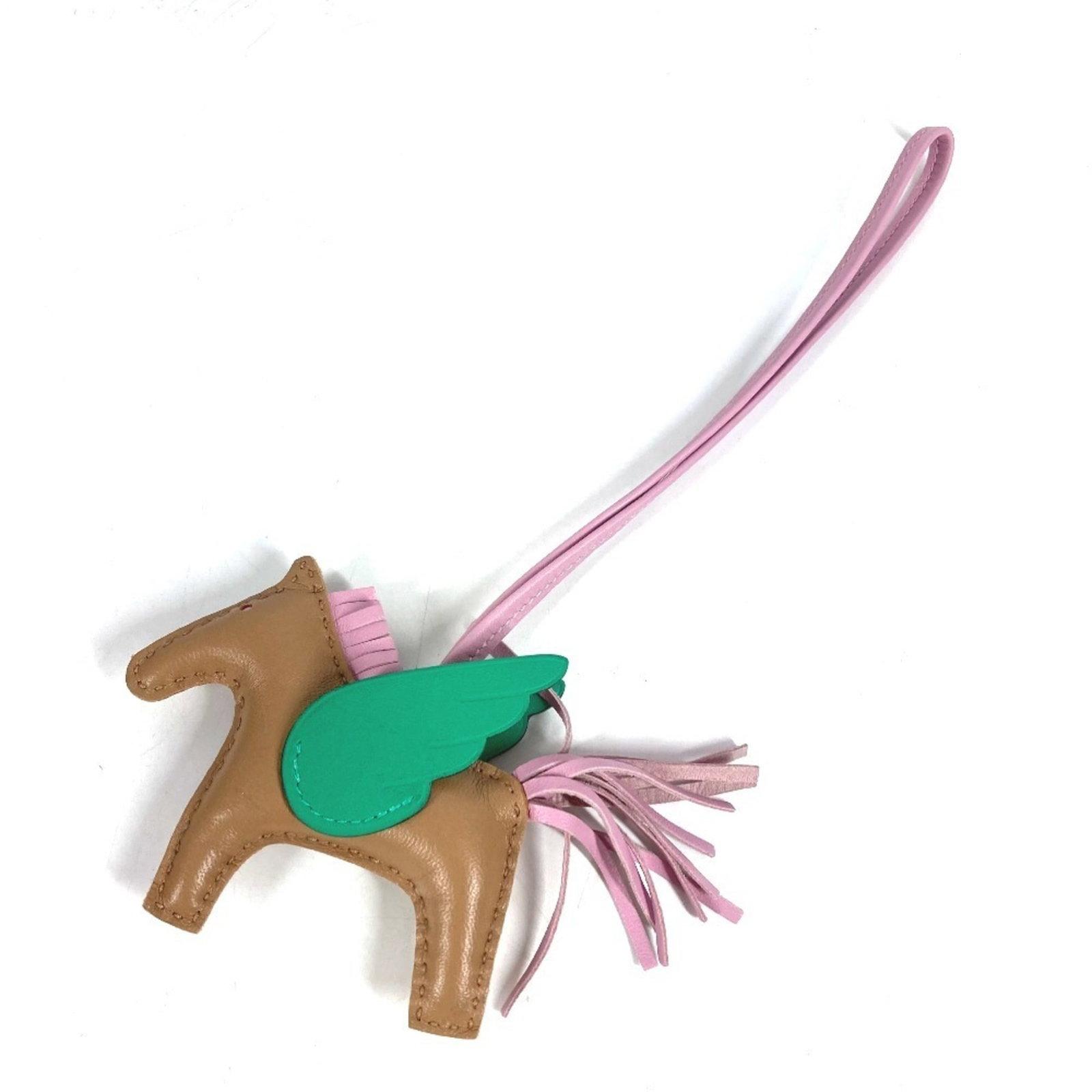 Agneau Handbag Charm Hermes: Agneau Handbag Charm Hermes Agneau Handbag Charm by Hermes features an elegant design in beige, green, and pink hues. Made from Agneau Milo material, this charm boasts a sophisticated look that adds a