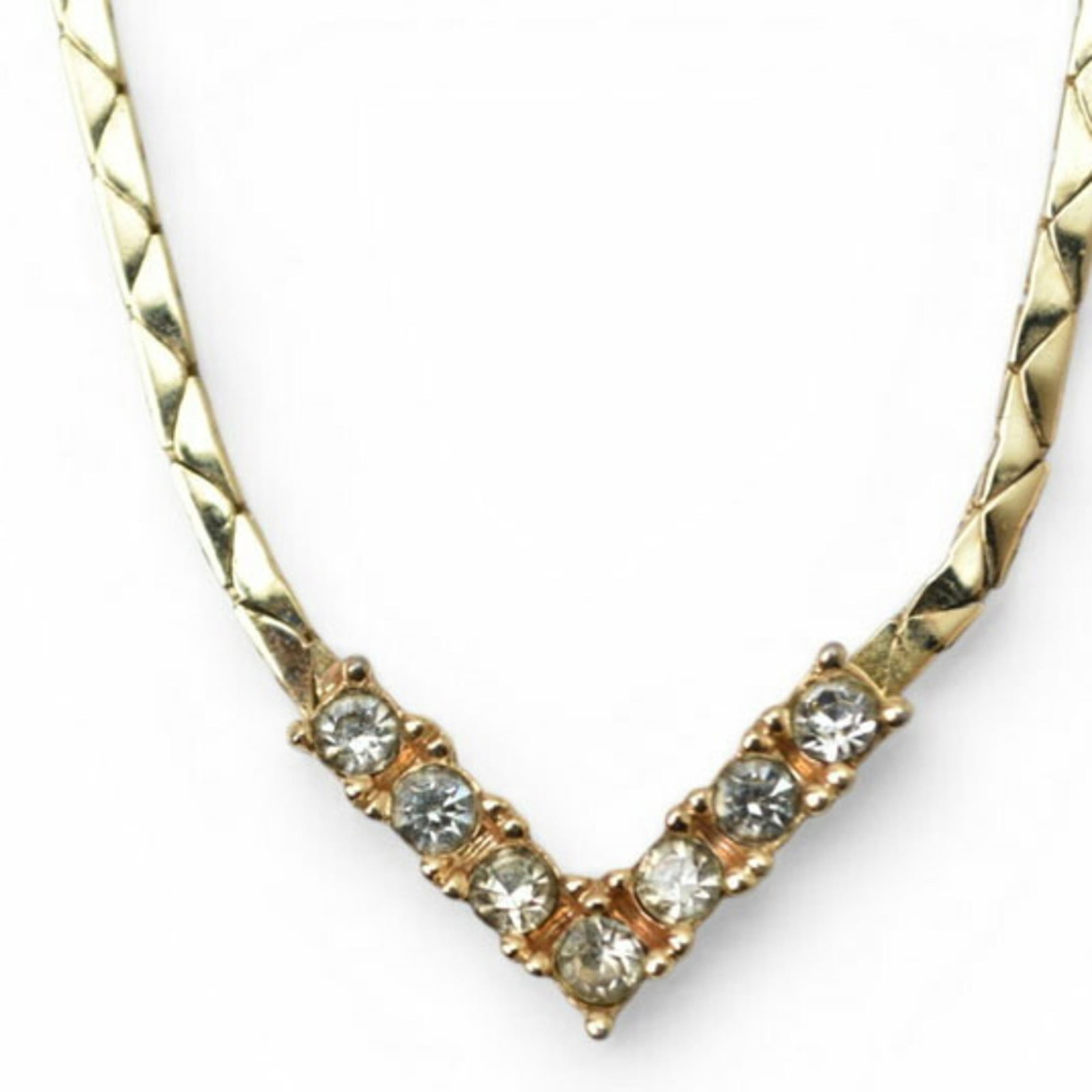 Christian Dior Necklace Gold V Rhinestone Pendant.: Christian Dior Necklace Gold V Rhinestone Pendant. Gold plating and rhinestones come together in a stunning Christian Dior necklace, featuring a V-shaped pendant. The gold plating adds a touch of luxu
