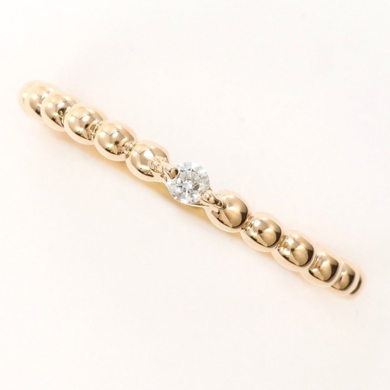 Pink gold 10k band ring kumikyoku: Pink gold 10k band ring kumikyoku Pink gold 10k band ring kumikyoku features a beautiful pink gold (10K) metal with a cubic zirconia stone, offering a stylish and elegant look. The ring's US size is 5