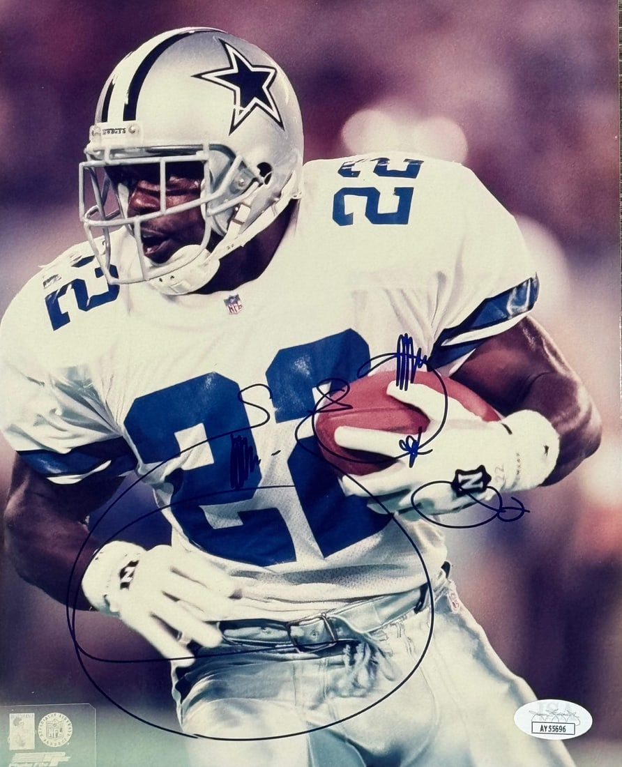 Smith Emmitt Autographed Football Photo JSA: Smith Emmitt Autographed Football Photo JSA Signed in blue sharpie across the front of an 8x10 football photo, Emmitt Smith's autograph adds a touch of NFL legend to this unique collectible. The James