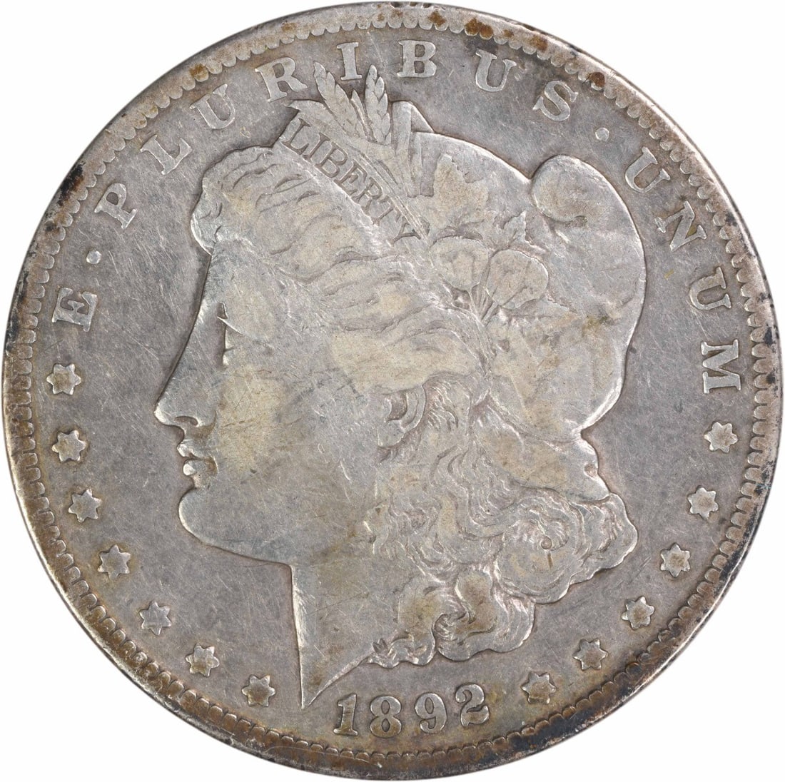 1892-CC Morgan Silver Dollar F Uncertified: 1892-CC Morgan Silver Dollar F Uncertified The 1892-CC Morgan Silver Dollar F Uncertified coin features a reeded edge and a diameter of 38.10 millimeters, showcasing its distinctive design elements. M