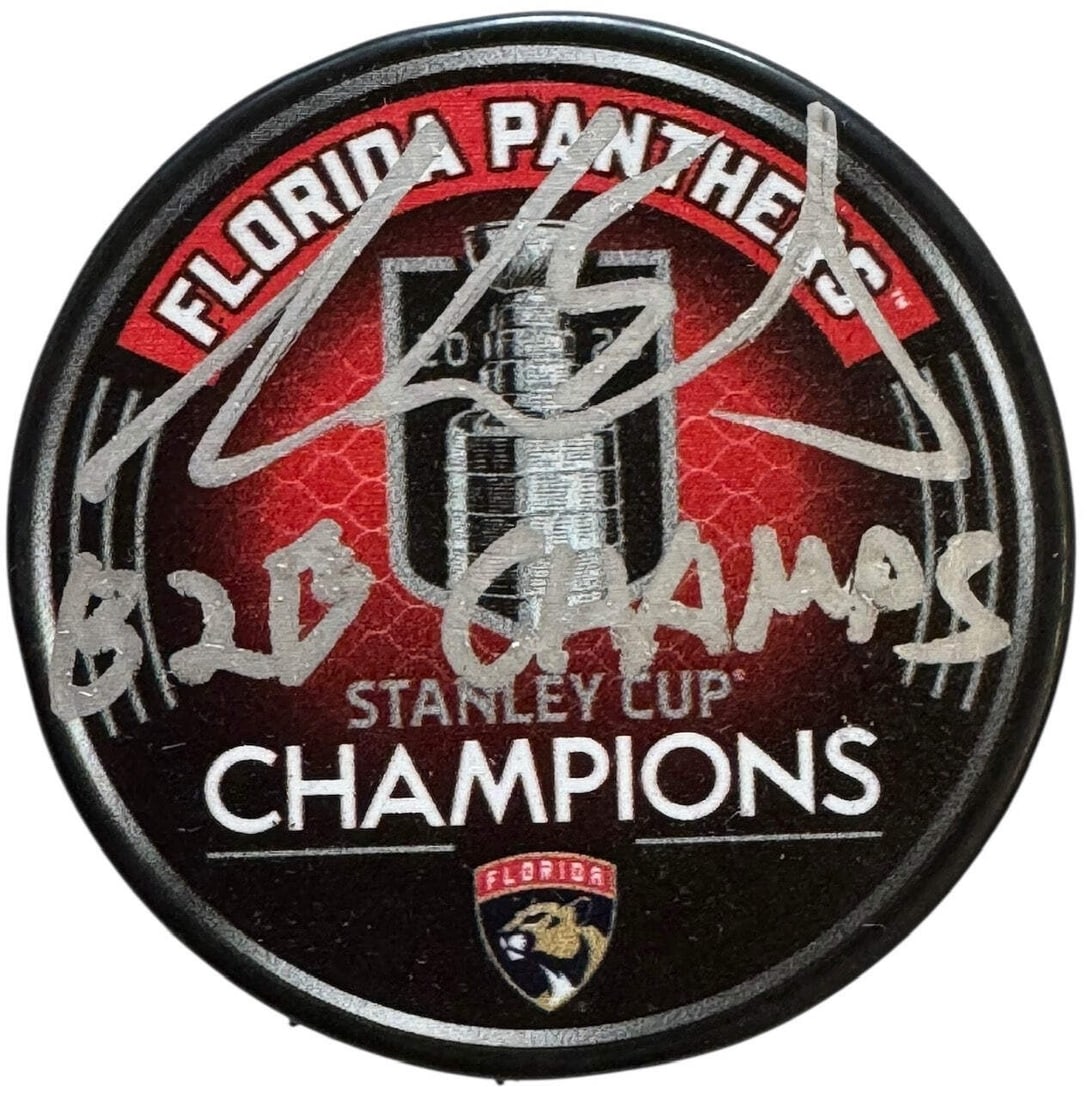 Aaron Ekblad Autographed 2025 Stanley Cup Champions Official Puck (Beckett Witne: Aaron Ekblad Autographed 2025 Stanley Cup Champions Official Puck (Beckett Witne Signed in silver paint pen across the front of the puck with inscription"B2B Champs" by Aaron Ekblad, a member of the 2
