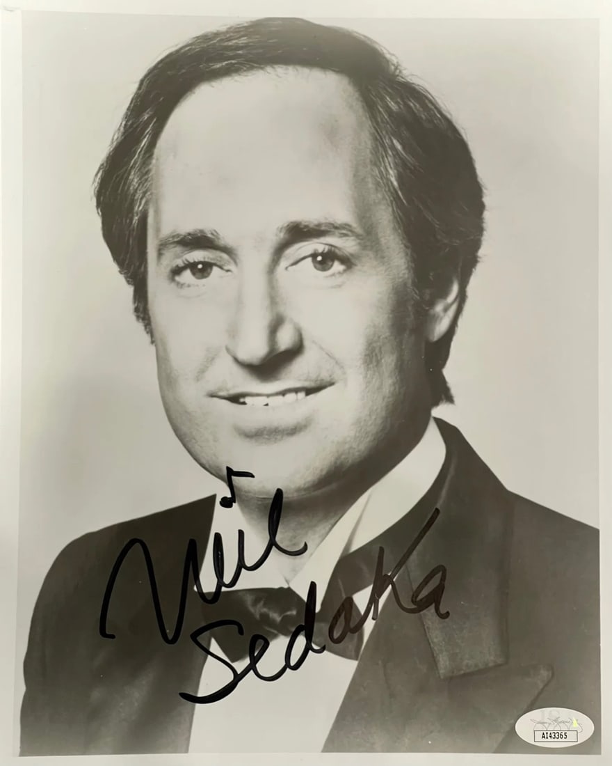 Neil Sedaka Celebrity Photo Autographed By JSA: Neil Sedaka Celebrity Photo Autographed By JSA Signed by Neil Sedaka in black sharpie, this 8x10 celebrity photo bears the artist's mark. The James Spence Authentication (JSA) logo verifies the signat
