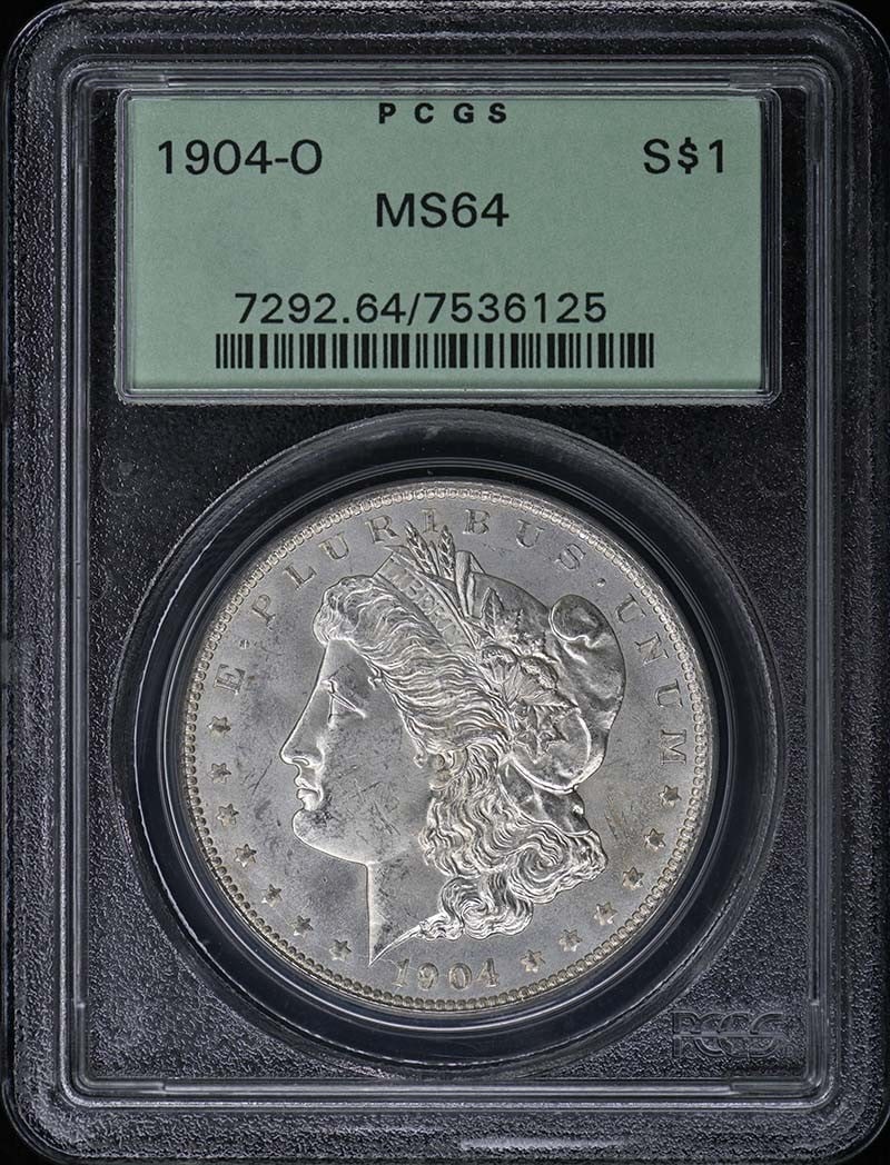 MS64 OGH PCGS 1904-O $1 Dollar: MS64 OGH PCGS 1904-O $1 Dollar MS64 OGH PCGS 1904-O $1 Dollar - A highly graded and preserved example of the iconic Morgan Dollar, certified by PCGS as MS64. This uncirculated coin features the distin