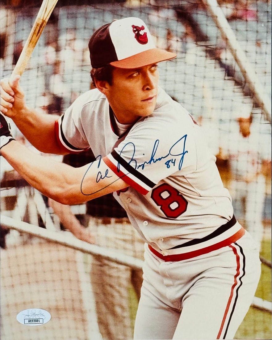 Cal Ripken Jr. Autographed 8x10 Baseball Photo (JSA): Cal Ripken Jr. Autographed 8x10 Baseball Photo (JSA) Cal Ripken Jr. signs his name in blue sharpie across the front of this official 8x10 baseball photo, bearing the authentication of James Spence Aut
