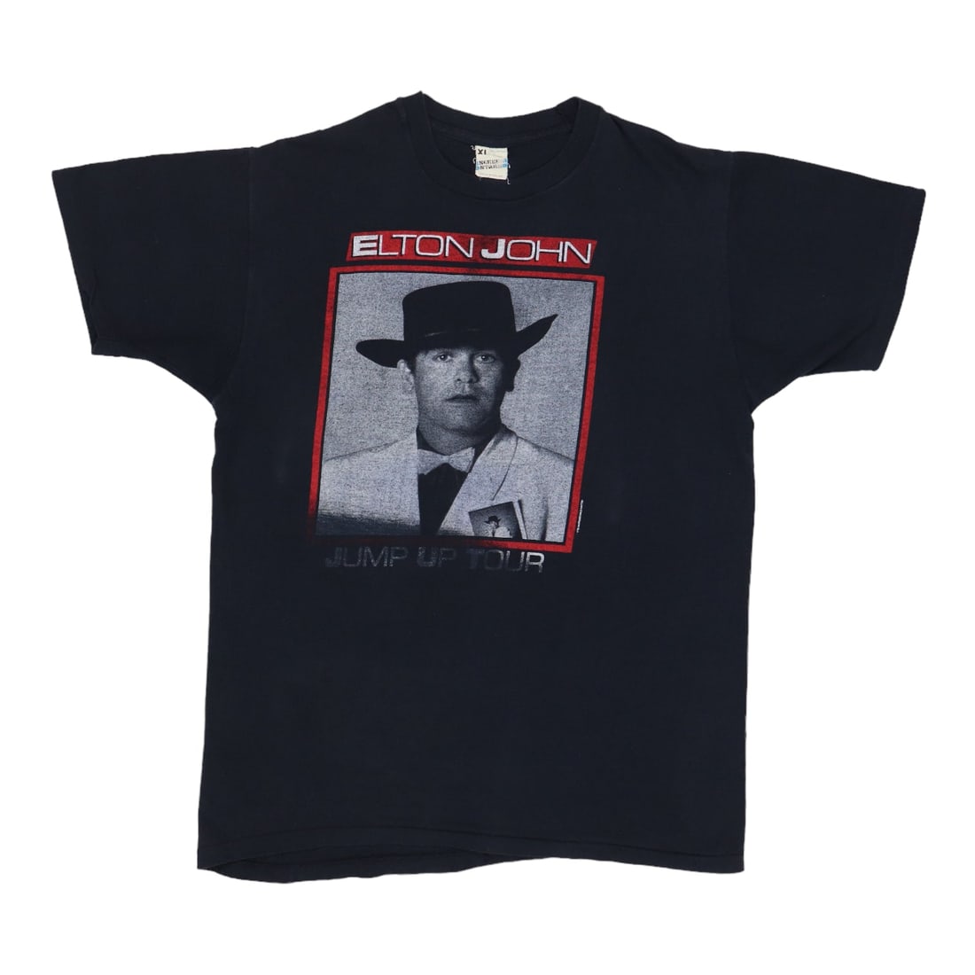 Elton John Jump Up Tour Shirt: Elton John Jump Up Tour Shirt Authentic Elton John Jump Up Tour Shirt for sale. This tour shirt features vibrant graphics and colors, capturing the energetic spirit of Elton John's iconic performance.