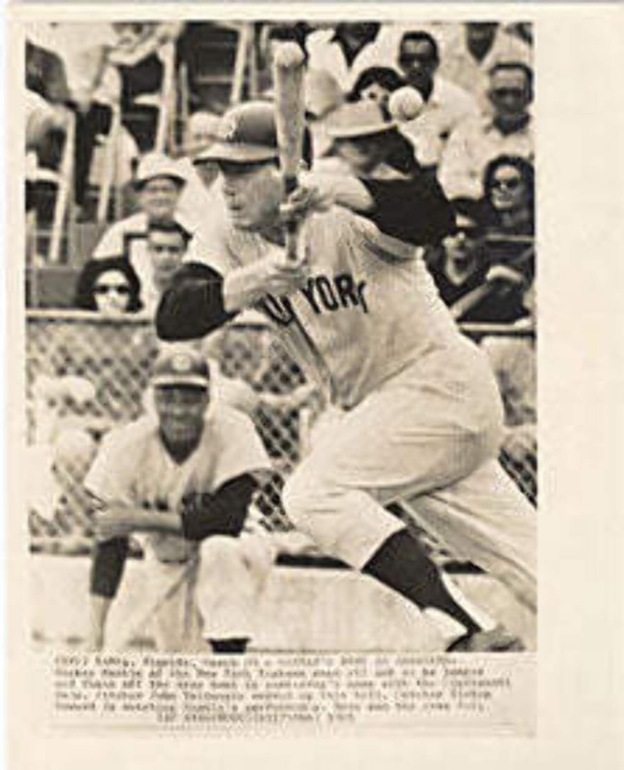 Mantle Mickey Batting Photo: Mantle Mickey Batting Photo Signed batting photo of Mickey Mantle, a legendary baseball player, taken from behind the plate. The photo showcases Mantle's impressive skills as a catcher and hitter, cap
