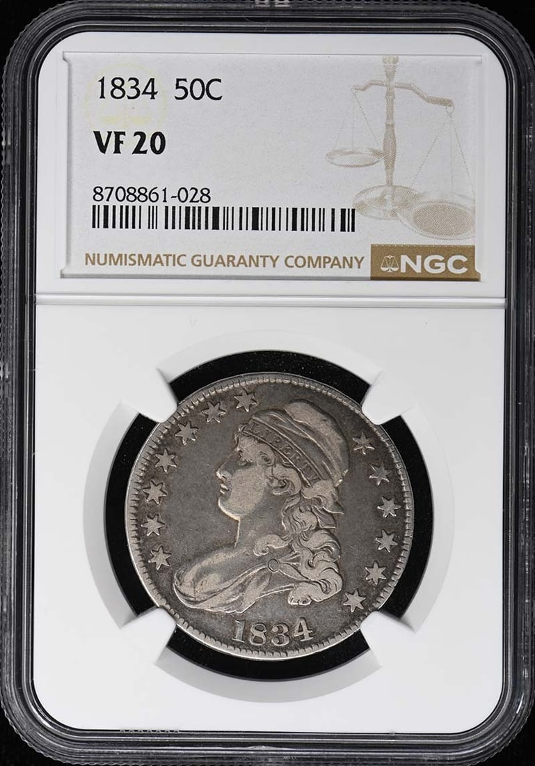 1834 Capped Bust, Lettered Edge 50C NGC VF20: 1834 Capped Bust, Lettered Edge 50C NGC VF20 The 1834 Capped Bust, Lettered Edge half dollar boasts a rich history, certified by the NGC as VF20. This circulated coin features the iconic design of