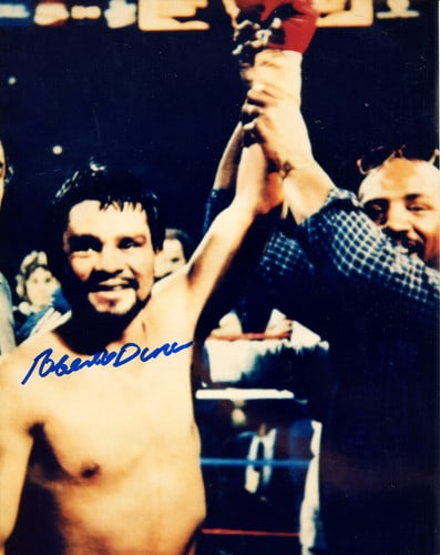 Roberto Duran Autographed 8x10 Photo: Roberto Duran Autographed 8x10 Photo Signed by boxing legend Roberto Duran, this 8x10 photo showcases the iconic fighter's signature in blue sharpie across the front. The high-quality image captures a