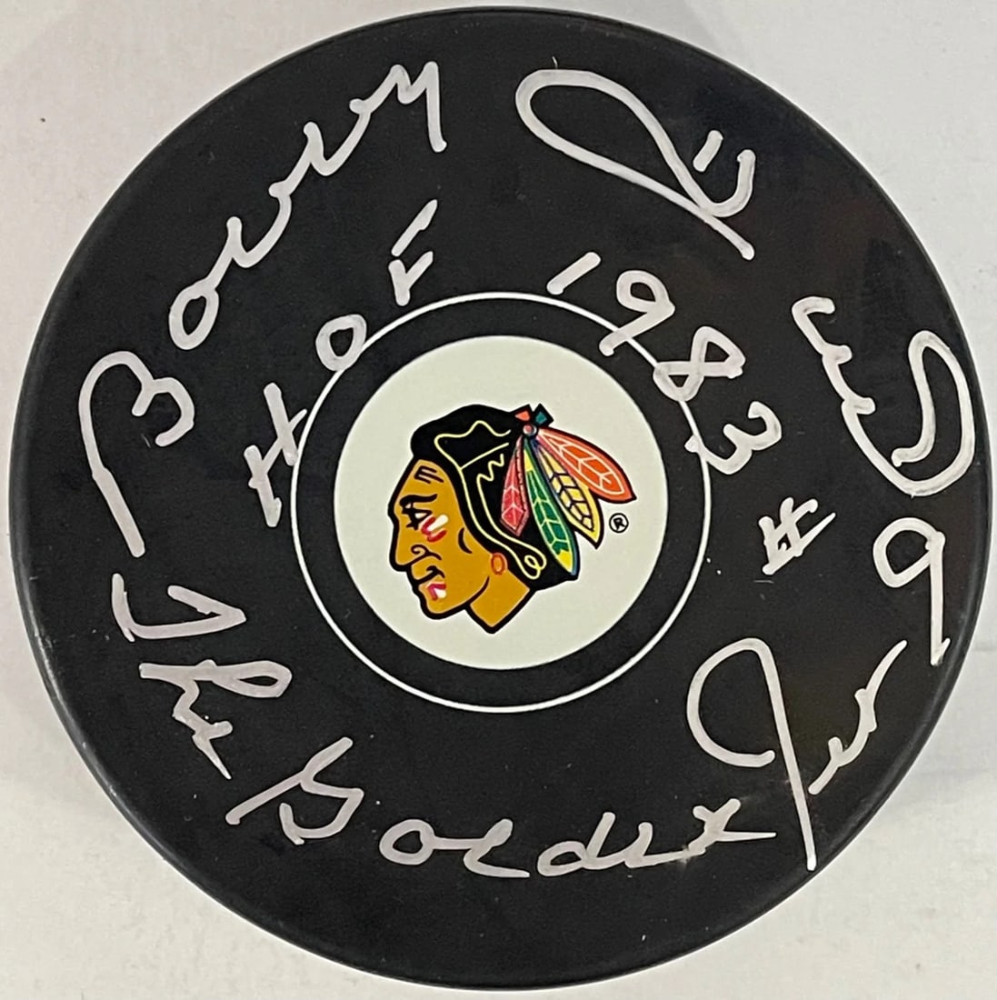 Bobby Hull Autographed Chicago Blackhawks Official Puck (JSA): Bobby Hull Autographed Chicago Blackhawks Official Puck (JSA) Signed across the front in silver sharpie by hockey legend Bobby Hull, this official Chicago Blackhawks puck bears an inscription commemor