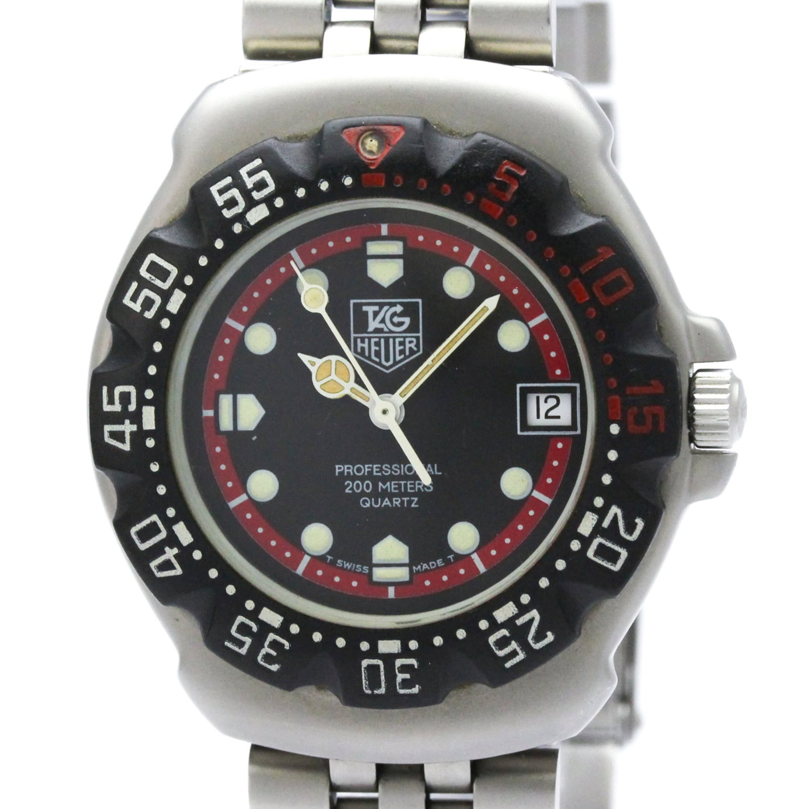 Wristwatch by Tag Heuer: Wristwatch by Tag Heuer Stainless steel case and band provide a sleek, sporty look for the wrist. The black dial features a quartz movement with date function, keeping time with precision. Weighing