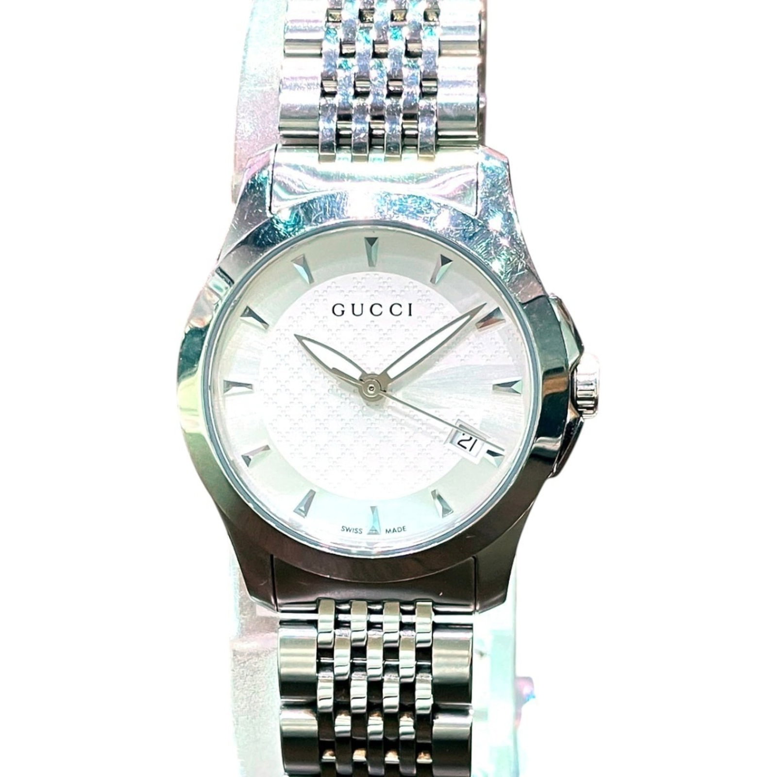 Gucci Wristwatch: Gucci Wristwatch Stainless steel case and band, the Gucci wristwatch boasts a sleek design with a white dial. Measuring 26mm in diameter, it's designed to fit wrists up to 15cm in size. This