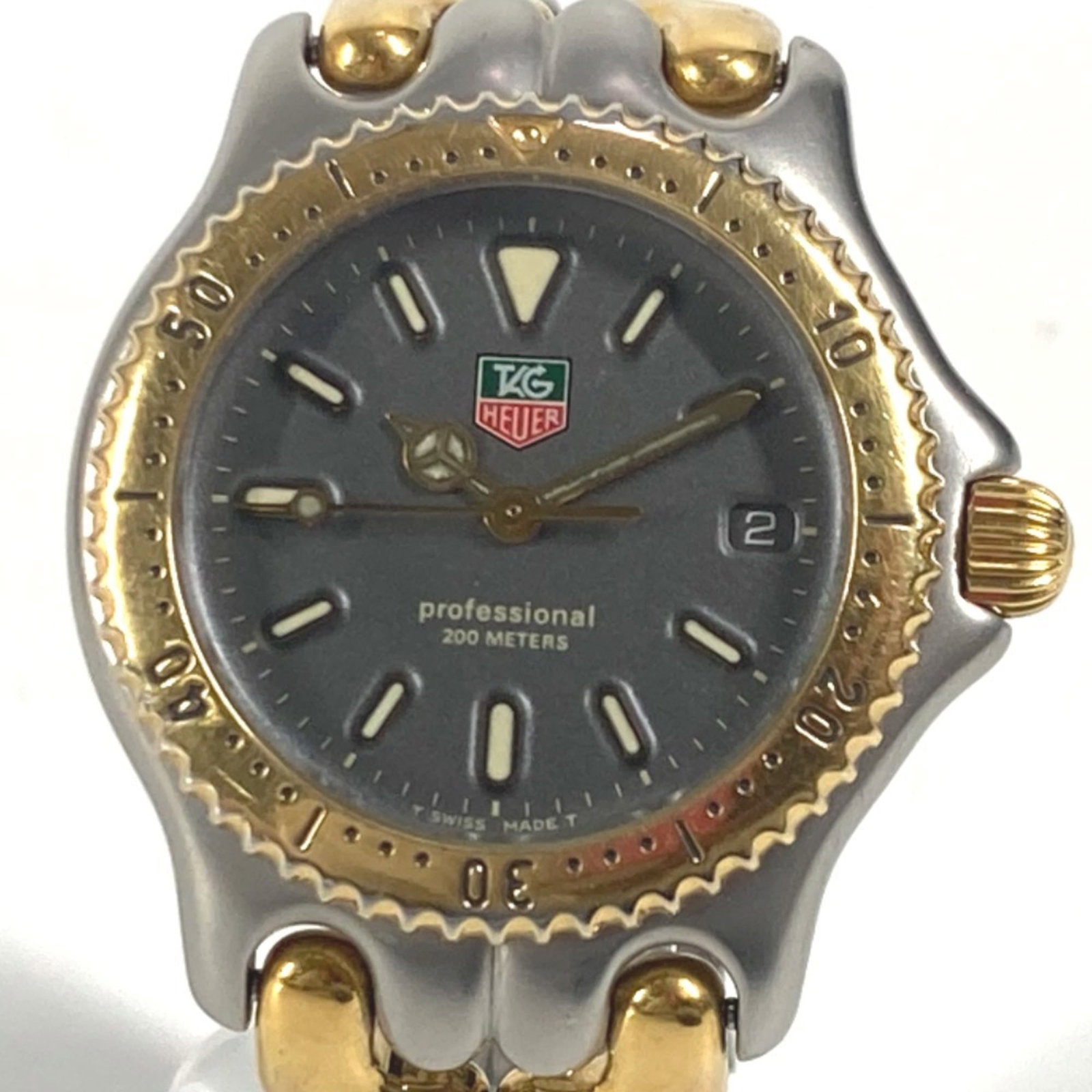 Wristwatch by Tag Heuer: Wristwatch by Tag Heuer Stainless steel case and band, gold and silver color options available. This quartz-powered Tag Heuer wristwatch features a sleek design with a diameter of 33mm. Item Specifics