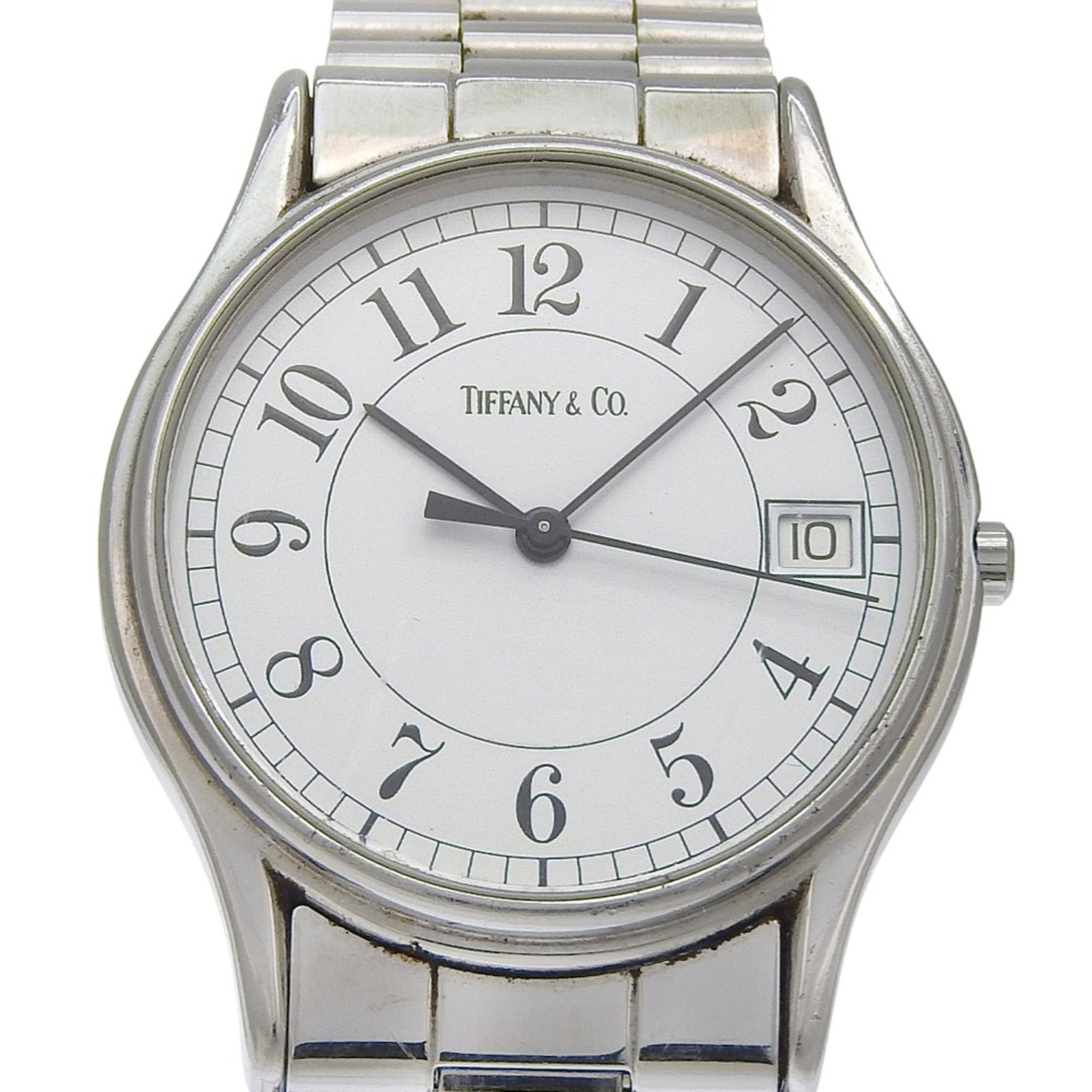 Tiffany Wristwatch: Tiffany Wristwatch Stainless steel case and band provide a sleek, durable finish for the quartz movement-powered Tiffany wristwatch. The white dial stands out against a neutral background, while the