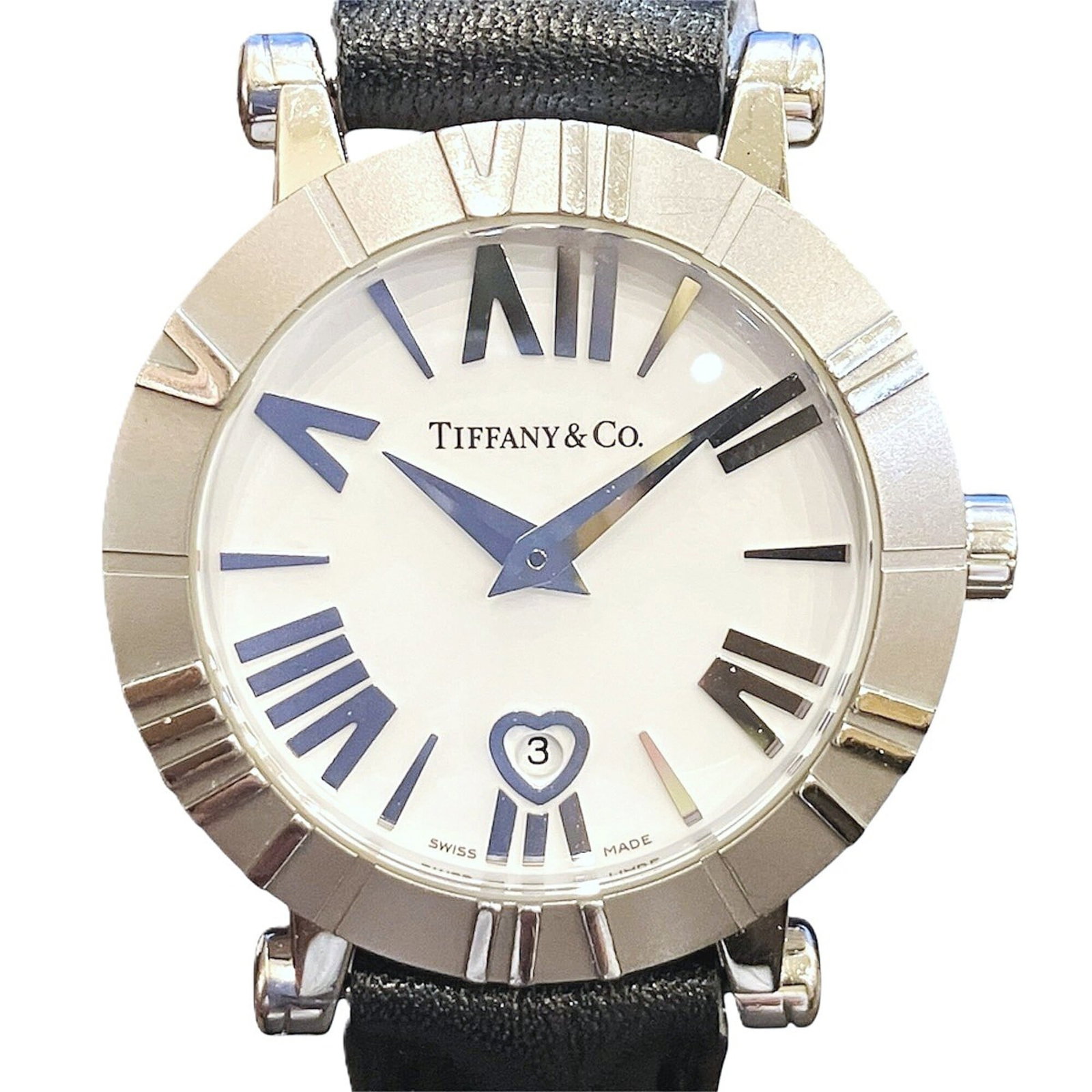 Tiffany Wristwatch: Tiffany Wristwatch Stainless steel case and leather band make for a sleek, versatile timepiece. The quartz movement ensures accurate timekeeping, while the white dial provides a clean and modern aesth