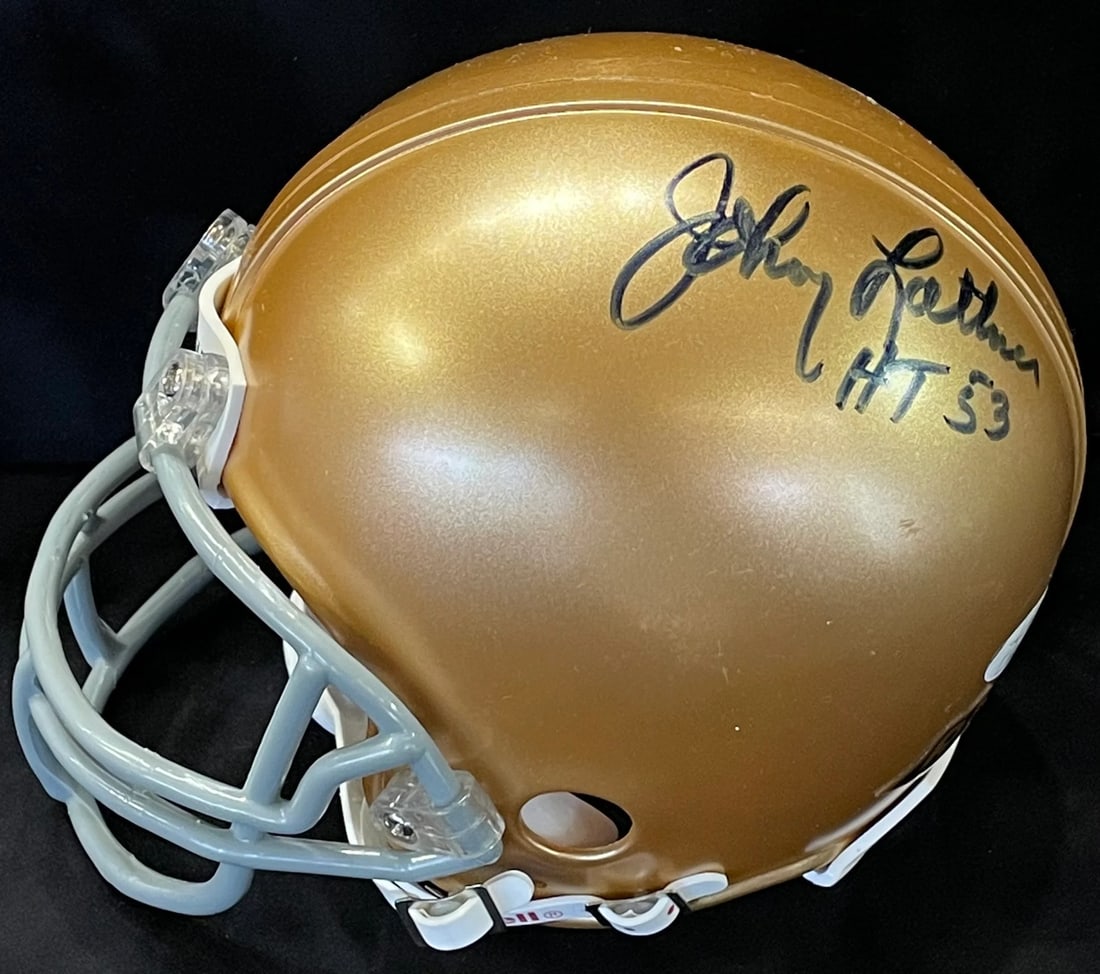 Johnny Lattner "HT 53" Autographed Notre Dame Mini Helmet (JSA): Johnny Lattner "HT 53" Autographed Notre Dame Mini Helmet (JSA) Johnny Lattner's "HT 53" autographed Notre Dame mini helmet bears a blue sharpie signature across its side, accompanied by an inscriptio