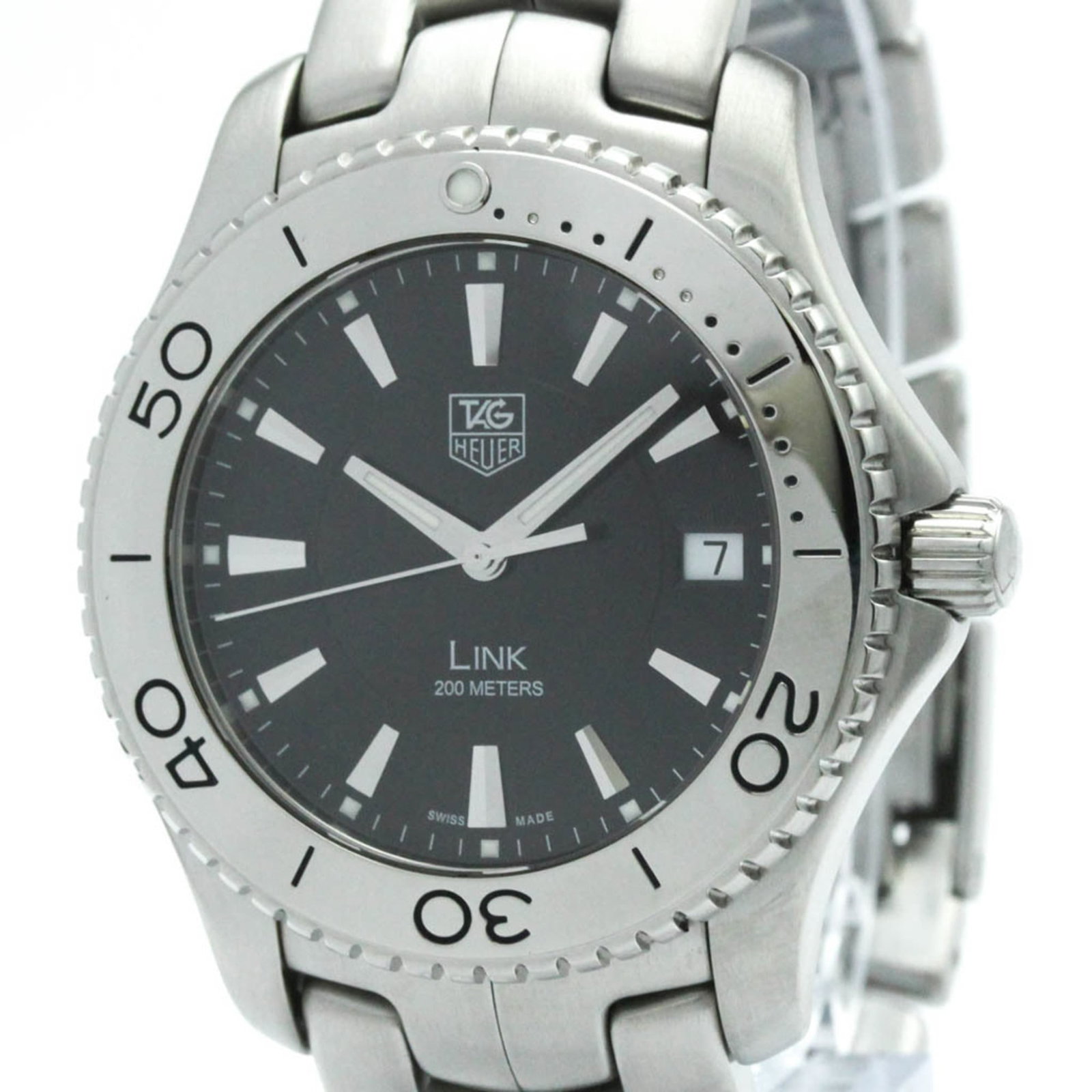 Wristwatch by Tag Heuer: Wristwatch by Tag Heuer Stainless steel case and band provide a sleek, sporty look for the Tag Heuer Link WJ1110 wristwatch. The black dial features a quartz movement with date function, making it a p
