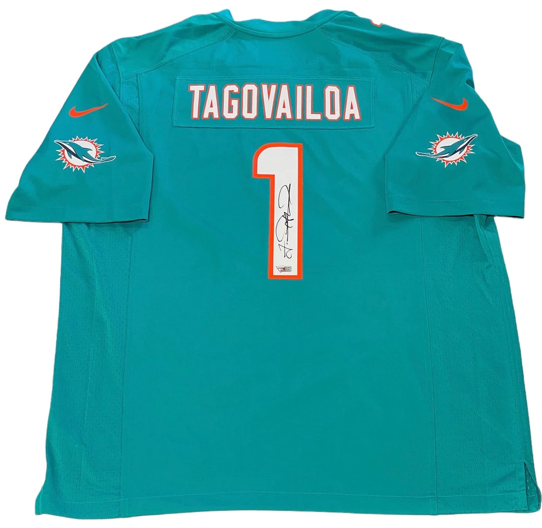 Tua Tagovailoa Autographed Dolphins Aqua Jersey (Fanatics): Tua Tagovailoa Autographed Dolphins Aqua Jersey (Fanatics) Tua Tagovailoa's sharpie signature across the jersey number on the back of this authentic Dolphins Aqua Jersey is unmistakable. The jersey, p