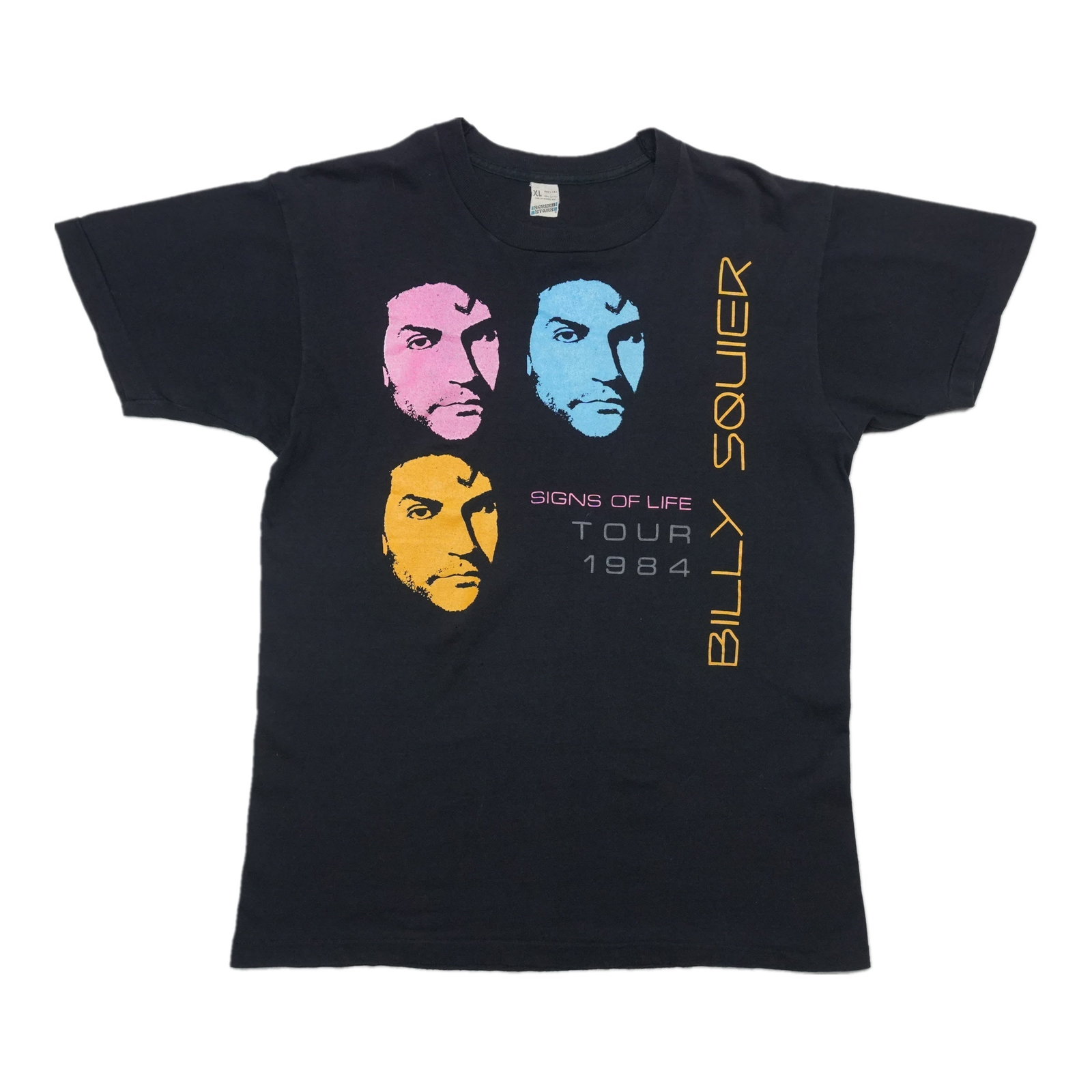 Billy Squier Signs Of Life Tour Shirt: Billy Squier Signs Of Life Tour Shirt Signed tour shirt from Billy Squier's iconic Signs Of Life Tour, bearing the artist's signature. This vintage tee showcases the band's energetic live performance 