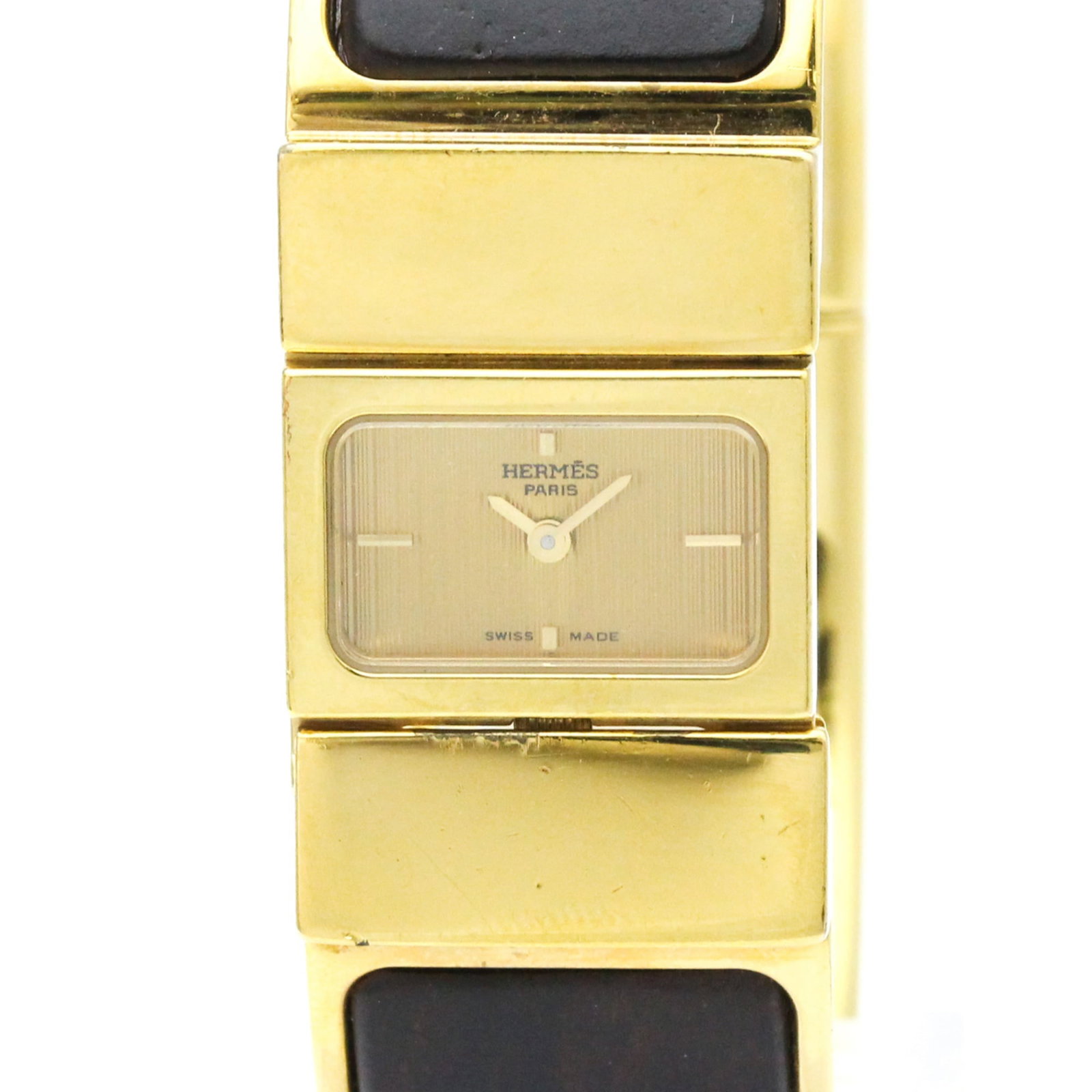 Hermes Wristwatch: Hermes Wristwatch Gold plated case and band, featuring a gold dial, this Hermes Loque wristwatch boasts a sleek design for formal occasions. With its quartz movement and compact size at 20mm, it's a s