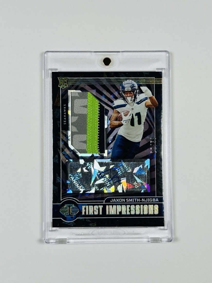 SMITH NJIGBA JAXON PANINI 2023 ILLUSIONS RPA/ 50 FIRST: SMITH NJIGBA JAXON PANINI 2023 ILLUSIONS RPA/ 50 FIRST Standard League NFL Autographed Panini Illusions Card Featuring Jaxon Smith-Njigba's First Impressions. This 2023 Panini Illusions autograph