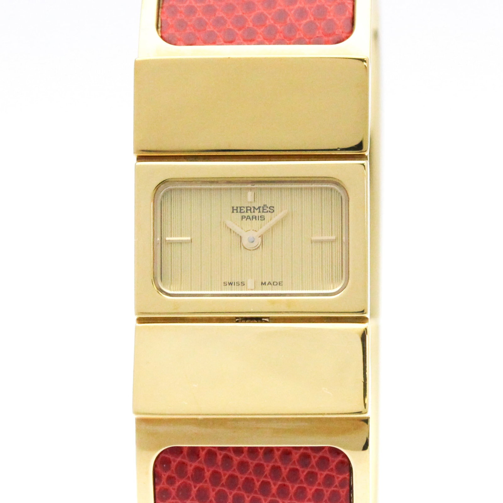 Hermes Wristwatch: Hermes Wristwatch Gold plated case and band, featuring a gold dial, this Hermes Loque wristwatch boasts a sleek design for formal occasions. With its quartz movement and compact size at 20mm, it's a
