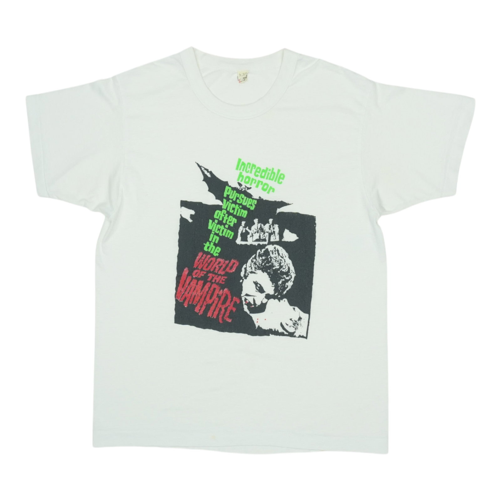 1980s World Of The Vampire Shirt: 1980s World Of The Vampire Shirt A vibrant relic from the 1980s, this World Of The Vampire shirt boasts a striking design featuring iconic imagery. With its bold graphics and nostalgic charm, this vin