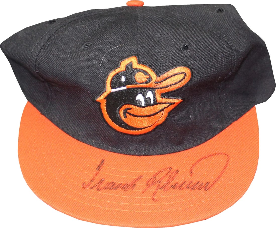 Autographed Frank Robinson Orioles Hat: Autographed Frank Robinson Orioles Hat Signed by Frank Robinson, the iconic Baltimore Orioles player and Hall of Famer, this authentic autographed hat features his signature in black sharpie across th