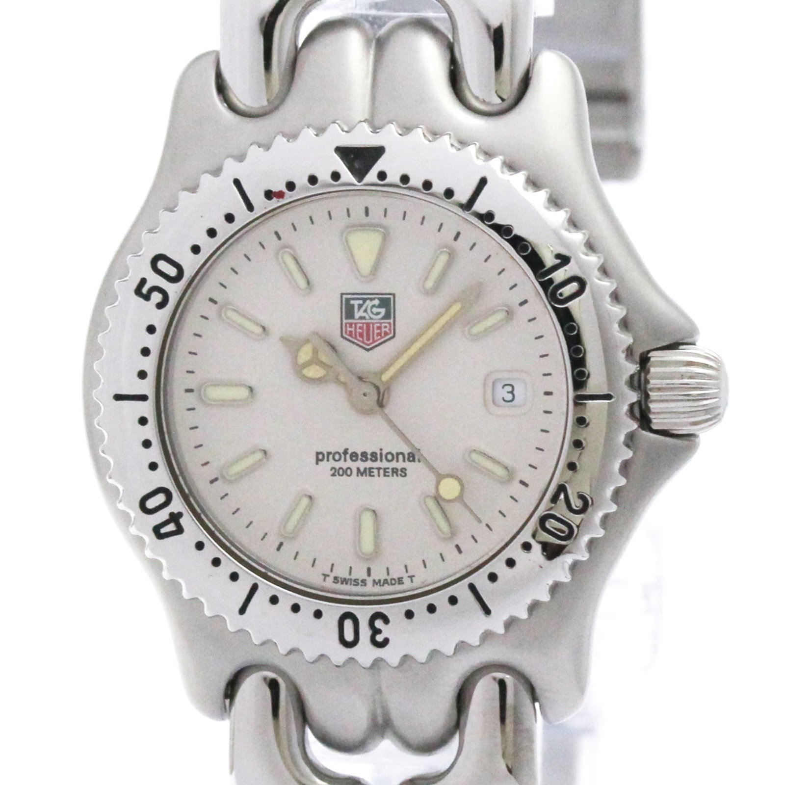 Wristwatch by Tag Heuer: Wristwatch by Tag Heuer Stainless steel case and band, white dial, quartz movement, and date function make this Tag Heuer Sel wristwatch a sleek and functional timepiece. With its compact 28mm size, i