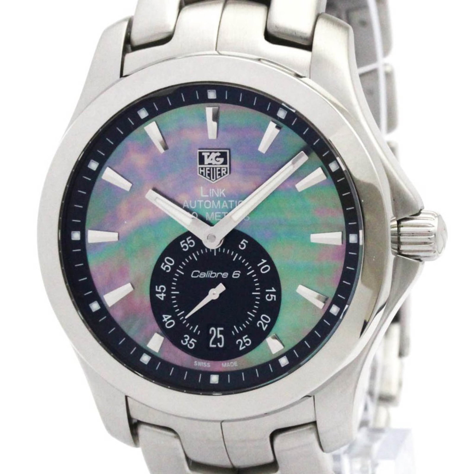 Wristwatch by Tag Heuer: Wristwatch by Tag Heuer Stainless steel case and band, the Tag Heuer Link watch boasts a sleek black shell dial. Powered by a self-winding automatic movement, this sporty timepiece features date