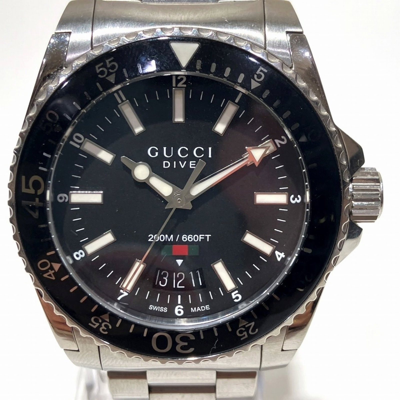 Wristwatch from Gucci: Wristwatch from Gucci Stainless steel case and band add an edgy touch to this black self-winding wristwatch from Gucci, measuring 40mm in diameter. The automatic movement powers a sleek design that