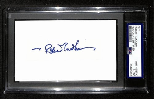 Robert Ludlum Signed/ Autographed Cut on 3x5 Index Card Author PSA/ DNA 194218: Robert Ludlum Signed/ Autographed Cut on 3x5 Index Card Author PSA/ DNA 194218 A piece of espionage history, this 3x5 index card bears an autographed cut from Robert Ludlum, the renowned author behind