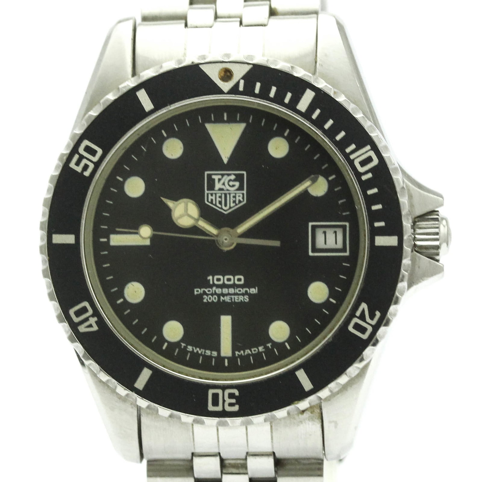 Wristwatch by Tag Heuer: Wristwatch by Tag Heuer Stainless steel case and band provide a sleek, sporty look for the Tag Heuer Professional watch. With its black dial and quartz movement, this timepiece keeps accurate time
