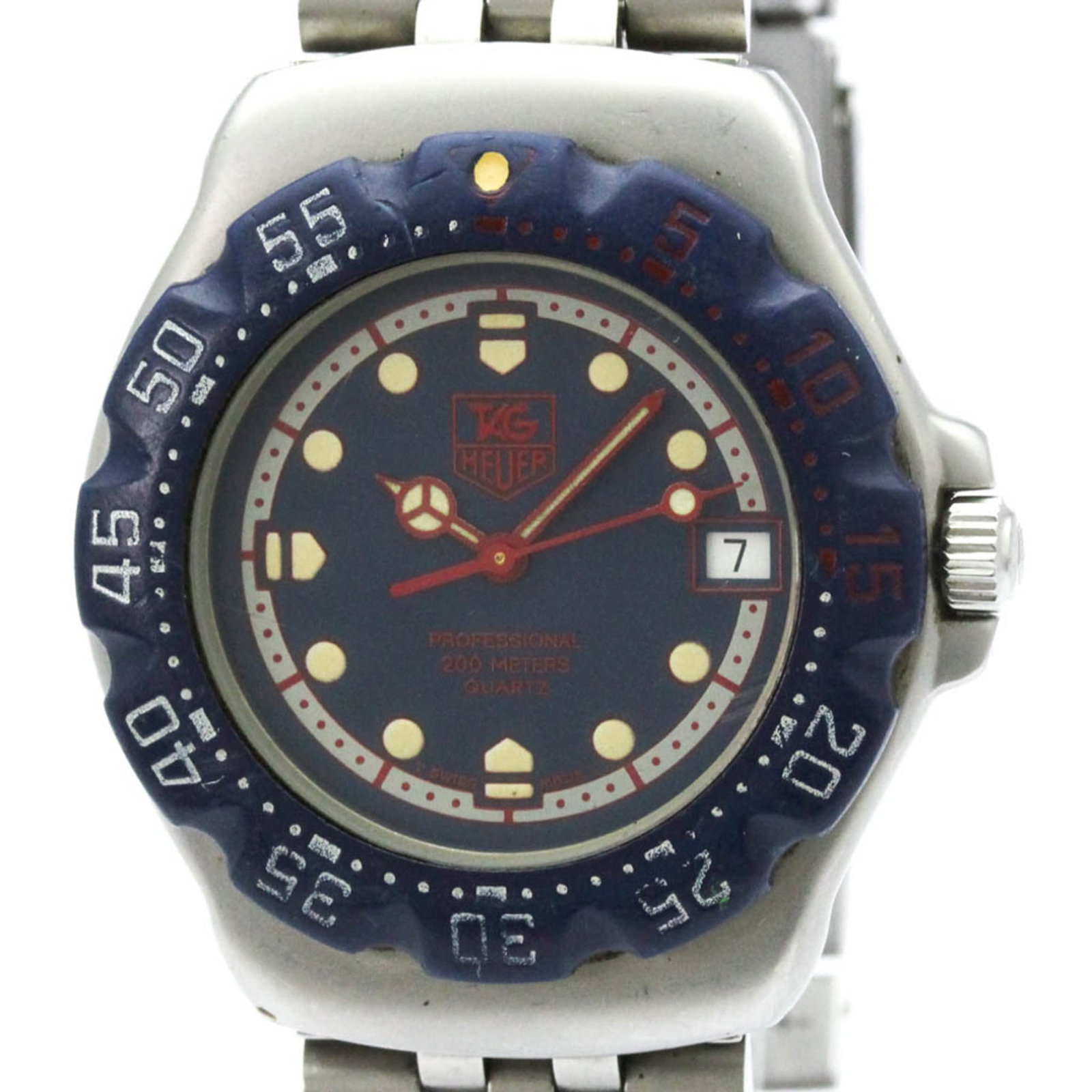 Wristwatch by Tag Heuer: Wristwatch by Tag Heuer Stainless steel case and band, the Tag Heuer WA1210 wristwatch boasts a sleek blue dial. With its quartz movement and date function, this sporty timepiece is designed for every
