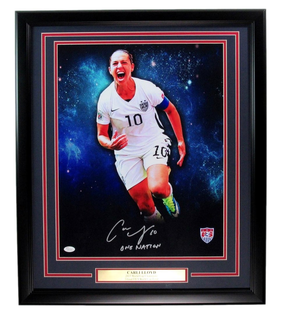 Signed Champs Photo Framed By Carli 200023 JSA 16x20 World 2015: Signed Champs Photo Framed By Carli 200023 JSA 16x20 World 2015 Signed by the US National Women's Team, this 16x20 photo is framed and presented in a unique way. The image captures a moment from