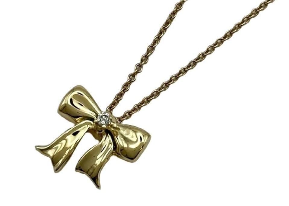 Tiffany & Co Diamond Ribbon Bow 18k Yellow Gold Pendant Necklace: Tiffany & Co Diamond Ribbon Bow 18k Yellow Gold Pendant Necklace Item Specifics: Pendant Shape: Bow Number Of Diamonds: 1 Closure: Spring Ring Occasion: Anniversary Birthday Christening Christmas Conf