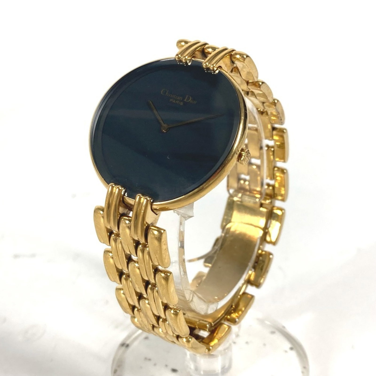 Wristwatch by Christian Dior: Wristwatch by Christian Dior The Christian Dior Bagira Men's Watch features a gold-plated case and stainless steel band, with a sleek black dial. This quartz-powered timepiece boasts a compact 31mm
