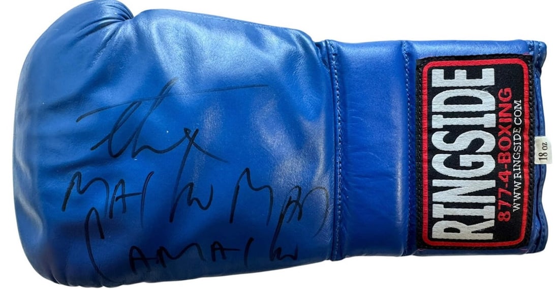 Hector Camacho Autographed Blue Ringside Left Boxing Glove (JSA): Hector Camacho Autographed Blue Ringside Left Boxing Glove (JSA) The Macho Man's iconic boxing glove, signed in black sharpie across the front with the inscription "The Macho Man". This blue ringside 