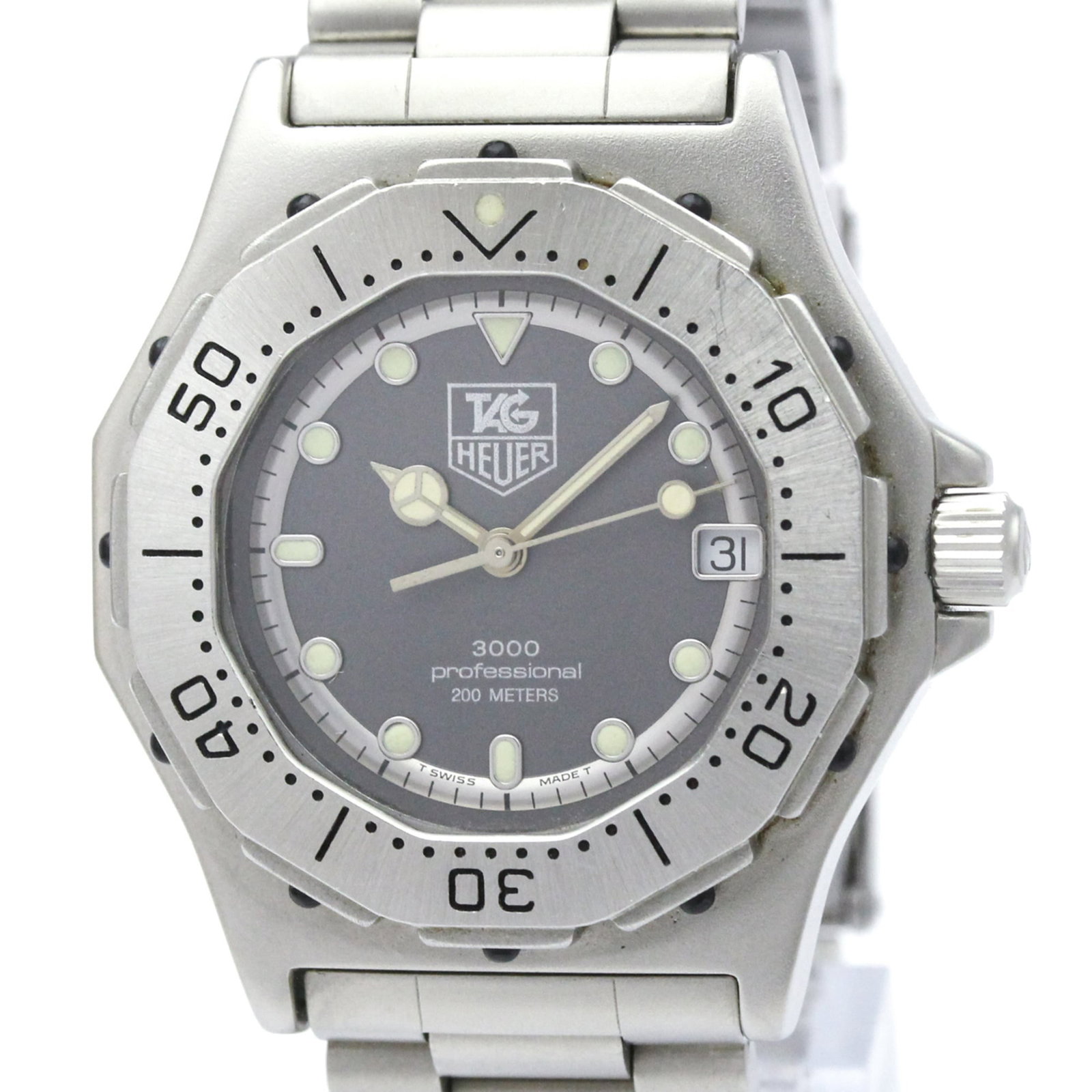 Tag Heuer Wristwatch: Tag Heuer Wristwatch Stainless steel case and band provide a sleek, sporty look, while the gray dial adds a touch of sophistication. This quartz-powered Tag Heuer 3000 Series wristwatch features a dat