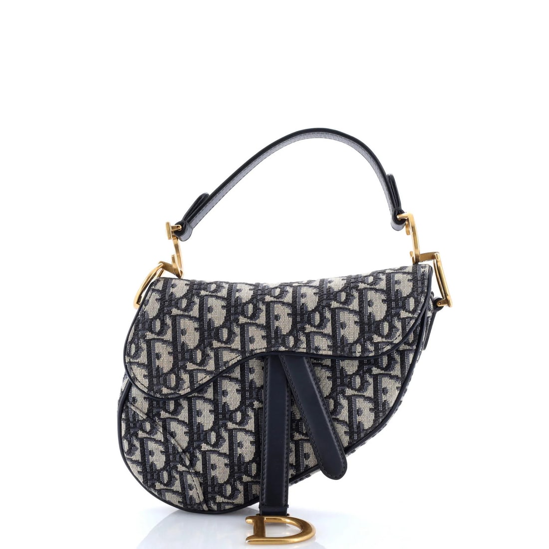 Christian Dior Saddle Oblique Mini Canvas: Christian Dior Saddle Oblique Mini Canvas The Christian Dior Saddle Oblique Mini Canvas is a stylish and compact shoulder bag, measuring 6" tall, 7" wide, and 2" deep. Its blue canvas exterior feature