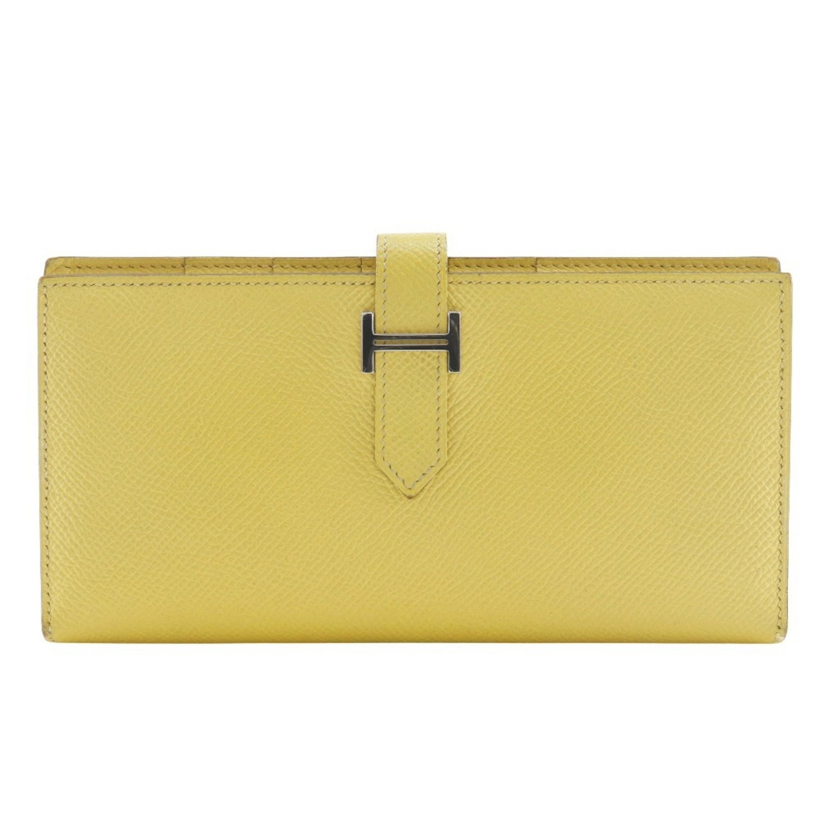 Epsom Leather Bi fold Wallet Hermes: Epsom Leather Bi fold Wallet Hermes Epsom leather, a rich and vibrant material, is used to craft this elegant bi-fold wallet from the renowned French brand Hermes. The sunny yellow hue adds a pop of