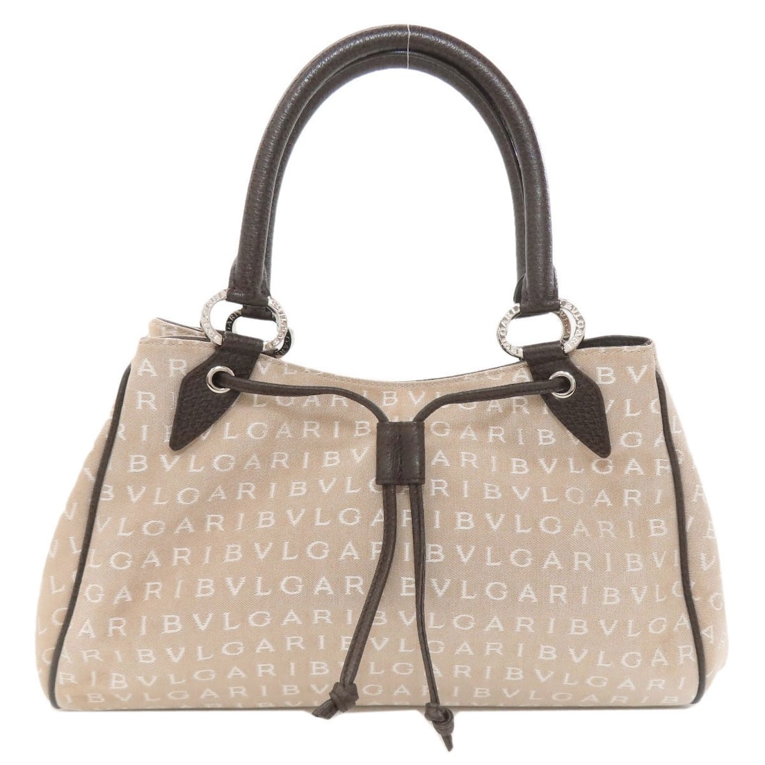 Mania Logo Canvas Bvlgari Handbag: Mania Logo Canvas Bvlgari Handbag Beige canvas BVLGARI handbag with a distinctive logo. This canvas handbag features the iconic BVLGARI logo, a notable design element. The beige exterior material