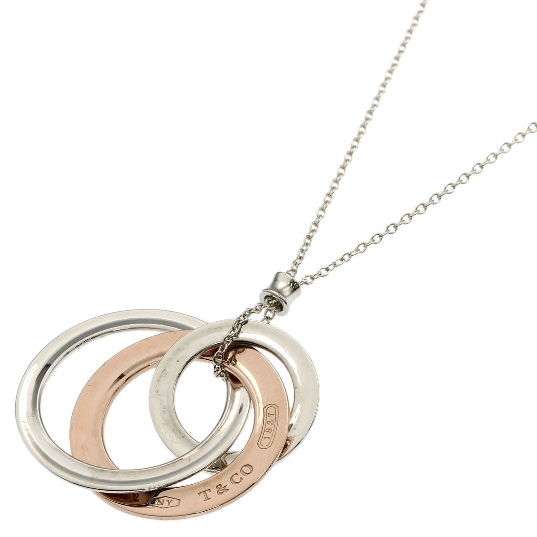Rubet Metal Tiffany Co Interlocking Necklace Silver: Rubet Metal Tiffany Co Interlocking Necklace Silver This Rubet Metal Tiffany Co Interlocking Necklace is a striking silver piece, featuring a unique interlocking design. Made from high-quality silver 