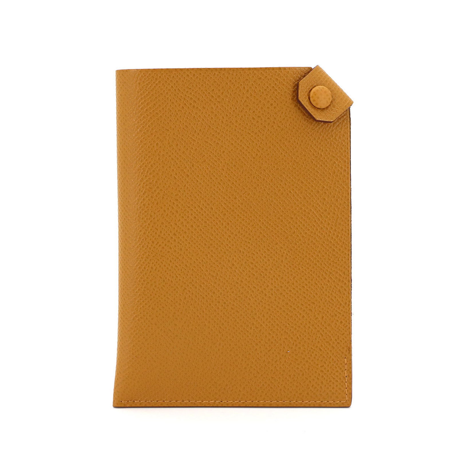 Epsom Leather Hermes Passport Cover: Epsom Leather Hermes Passport Cover Epsom leather wraps around the edges of this natural sable Hermes passport cover, adding a touch of sophistication to its classic design. Measuring 14cm x 10cm x