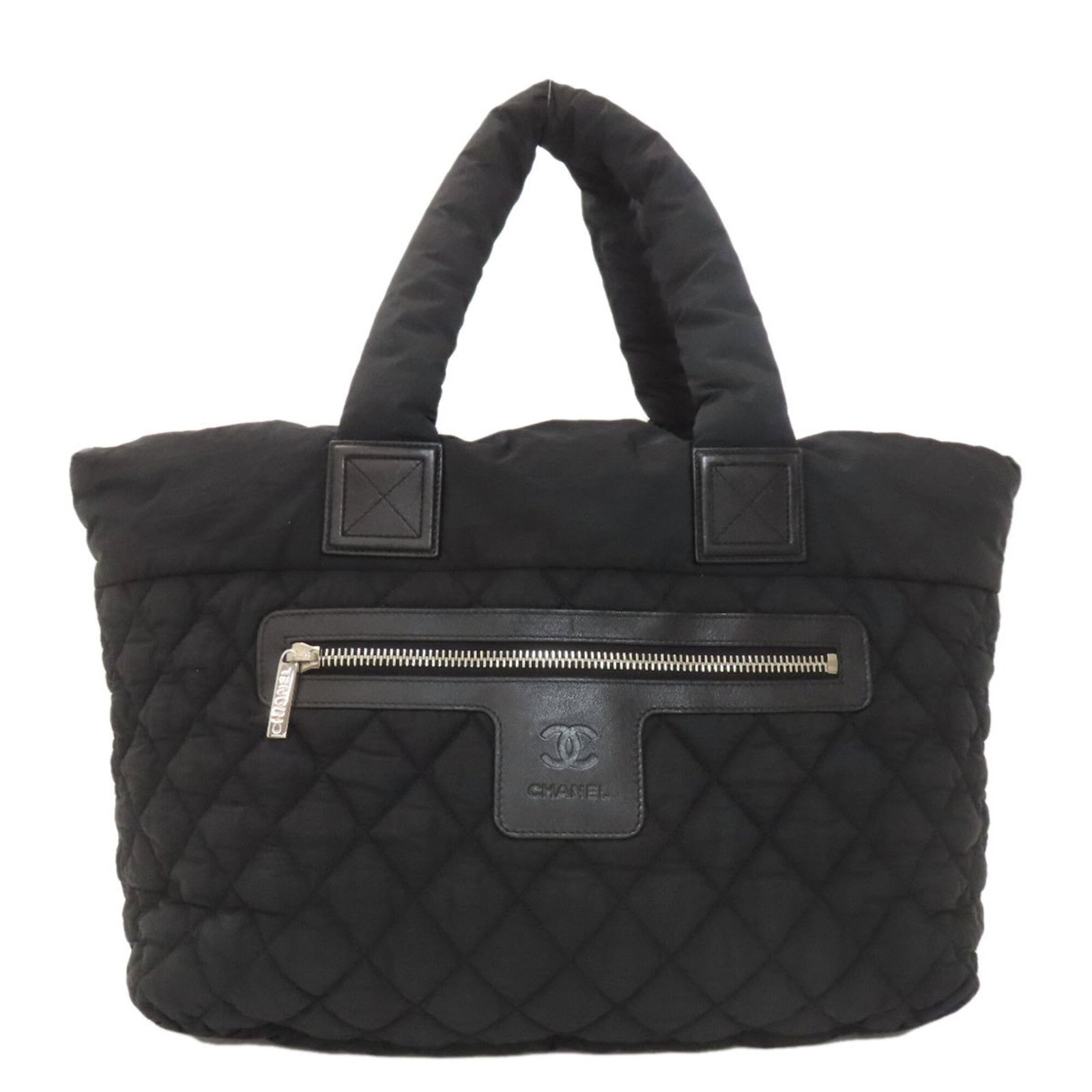Nylon Tote Bag By Chanel: Nylon Tote Bag By Chanel Black Nylon Tote Bag by Chanel, 30cm x 50cm x 16cm, with Guarantee card. This Chanel tote bag is made from high-quality nylon and features a sleek black design. The bag comes