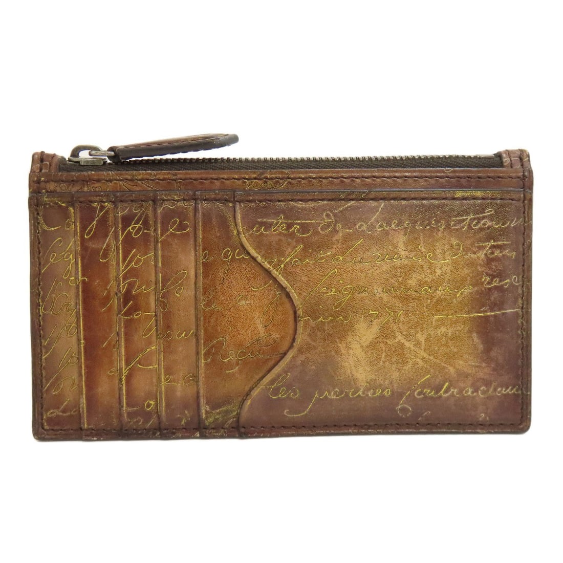 Coin purse leather Berluti Calligraphy: Coin purse leather Berluti Calligraphy Berluti's coin purse leather is a masterclass in understated elegance, with a rich brown color that exudes sophistication. This beautifully crafted leather coin